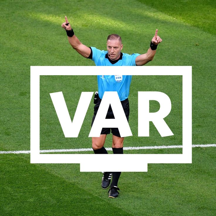 A football referee using VAR to ensure fair play in line with the main objective of the game.